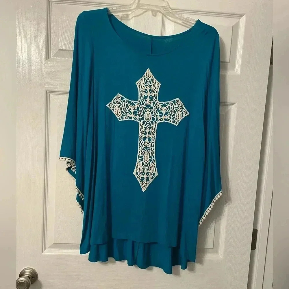Teal blue blouse with cross on the front. Bell sleeves - back longer than front